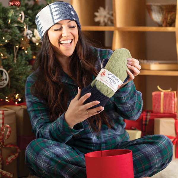 Vermont Mitten Co. Headband - Holiday scene with model wearing headband and holding VT. Mittens