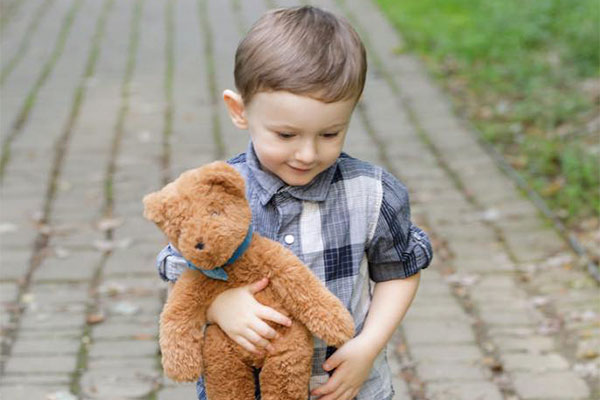 An image of a boy cuddling 5 15-inch Buddy bear Bears