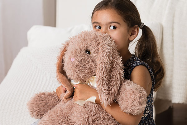 An image of a young child cuddling with the World's Softest Bunny