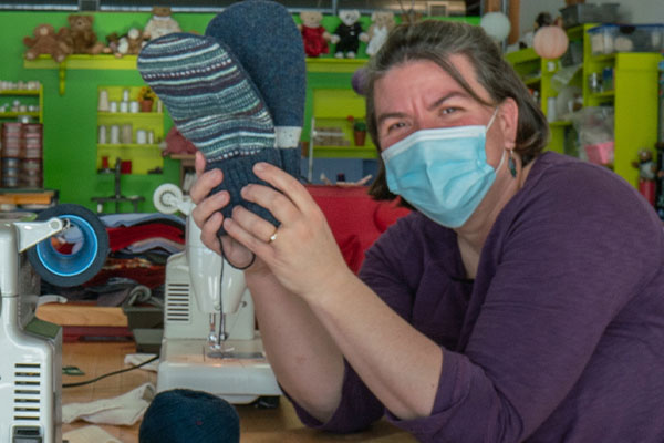 An image Jen Ellis - creator of the famous Bernie Mittens® - making mittens at our factory in Shelburne, Vt