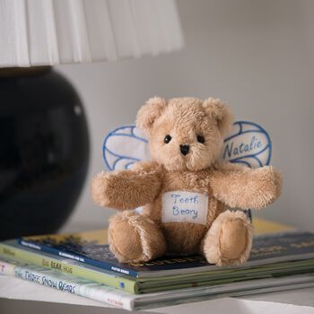 6" Tooth Beary - Seated tan plush bear with pocket on the belly for a lost tooth and white wings with blue embroidery