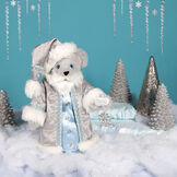 15" Limited Edition Snowflake Santa - front view of gray standing bear in a silver and fur long coat with crystal snowflake in a winter scene image number 0