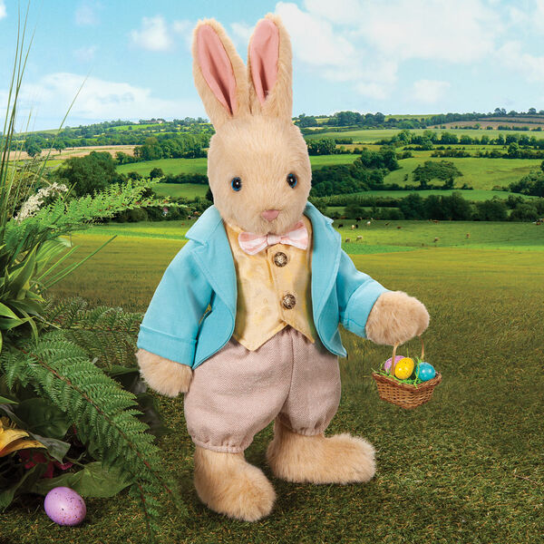 16" Limited Edition Easter Bunny - Jointed Standing Buttercream Rabbit in a turquoise jacket, yellow vest with bow tie, tan knickers holding an Easter basket with eggs. Rabbit is in an outdoor setting.  image number 0