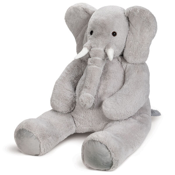 6' Giant Cuddle Elephant - 3/4 view of seated grey plush elephant with white fabric tusks, floppy ears and long trunk image number 7
