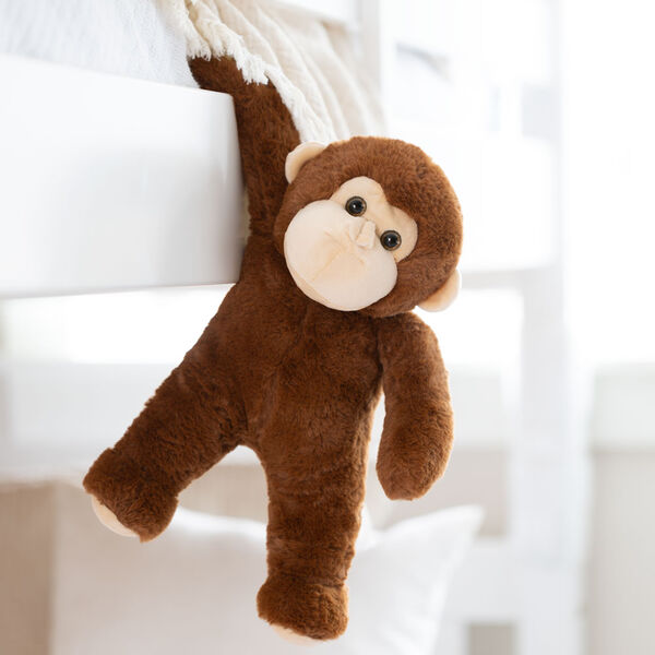 13" Monkey Snuggle Pal - Hanging brown monkey weighted stuffed animal in living room scene image number 2