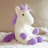 13" Unicorn Snuggle Pal - Three quarter view of seated ivory unicorn weighted stuffed animal with model in bedroom scene image number 2