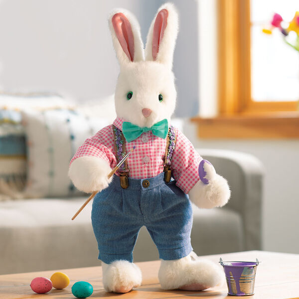 16" Limited Edition Easter Bunny 2022 - Front view of vanilla standing rabbit in pants and shirt with paintbrush and paint in Easter scene image number 2