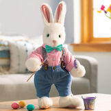 16" Limited Edition Easter Bunny 2022 - Front view of vanilla standing rabbit in pants and shirt with paintbrush and paint in Easter scene image number 2