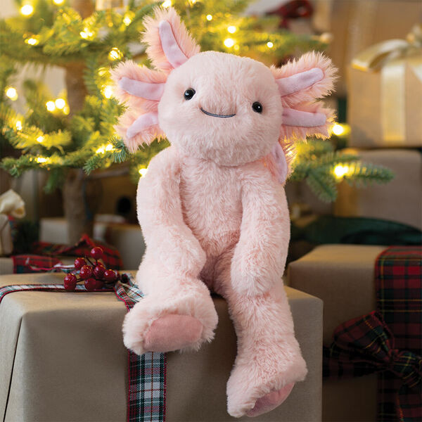 15" Buddy Axolotl - Front view of pink Axolotl weighted stuffed animal on a stack of Christmas gifts image number 2