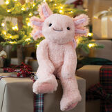 15" Buddy Axolotl - Front view of pink Axolotl weighted stuffed animal on a stack of Christmas gifts image number 2