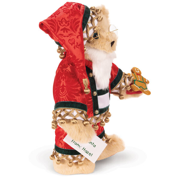 15" Limited Edition Christmas Cookie Santa Bear - Side view of standing jointed buttercream bear with blue eyes wearing satin pajamas, a matching nightcap, a white beard, and glasses and holding a cookies and list. image number 4