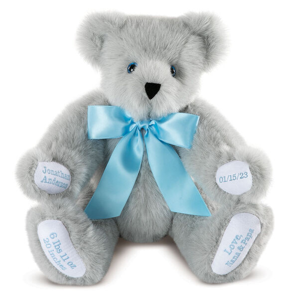 15" Premium Baby Boy Bear - Front view of seated jointed gray bear with white paw pads and chose of eye color wearing a blue satin bow. All 4 paw pads are personalized with baby's name, birth date, pounds and inches at birth.  image number 0