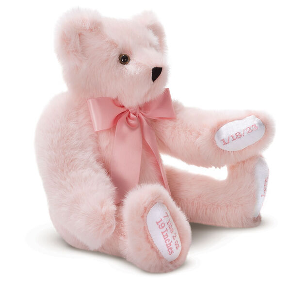 15" Premium Baby Girl Bear - Three quarter view of seated jointed pink bear with white paw pads and chose of eye color wearing a blue satin bow. All 4 paw pads are personalized with baby's name, birth date, pounds and inches at birth.  image number 2