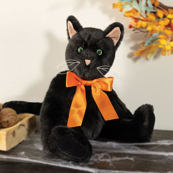 15" Classic Black Cat - Front view of seated jointed cat with pink ears, black foot pads and green glow in the dark eyes dressed in an orange satin bow - Black fur image number 1