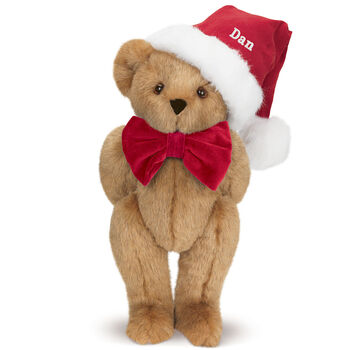 15" Christmas Classic Bear - Standing jointed bear dressed in white red velvet bow tie with red velvet santa hat with white fur trim. Hat is personalized with "Dan" above the fur  - Honey brown fur