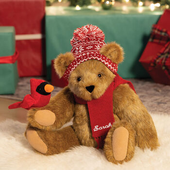 15" Season's Greetings Bear - Front view of seated jointed bear dressed in a knit red and white nordic patterned hat with red scarf and holding a red cardinal with Christmas gifts