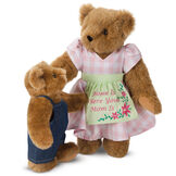 15" Home Is Where Your Mom Is Bear - Front view of standing jointed bear wearing a pink gingham dress, green bow and apron with floral embroidery and says "Home is Where Your Mom Is" with honey cub dressed in denim overalls - Honey brown fur image number 10