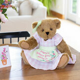 15" Home Is Where Your Mom Is Bear - Front view of standing jointed bear wearing a pink gingham dress, green bow and apron with floral embroidery and says "Home is Where Your Mom Is" with models image number 2