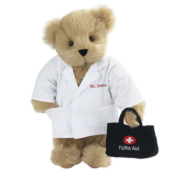 15" Doctor Bear - Front view of standing jointed bear dressed in white labcoat holding a doctor bag that is embroidered wth "FURst Aid" and a medical cross in red and white personalized with "Dr. Jones" on left chest in red - Maple brown fur image number 3