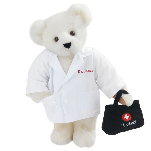 15" Doctor Bear - Front view of standing jointed bear dressed in white labcoat holding a doctor bag that is embroidered wth "FURst Aid" and a medical cross in red and white personalized with "Dr. Jones" on left chest in red - Vanilla white fur image number 2