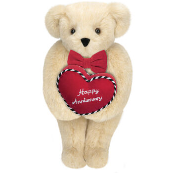 15" Happy Anniversary Bear - Front view of standing jointed bear dressed in a red velvet bow tie and holding a red heart pillow that says' Happy Anniversary" in white  - Buttercream brown fur