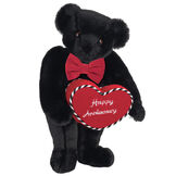 15" Happy Anniversary Bear - Front view of standing jointed bear dressed in a red velvet bow tie and holding a red heart pillow that says' Happy Anniversary" in white  - Black fur image number 3