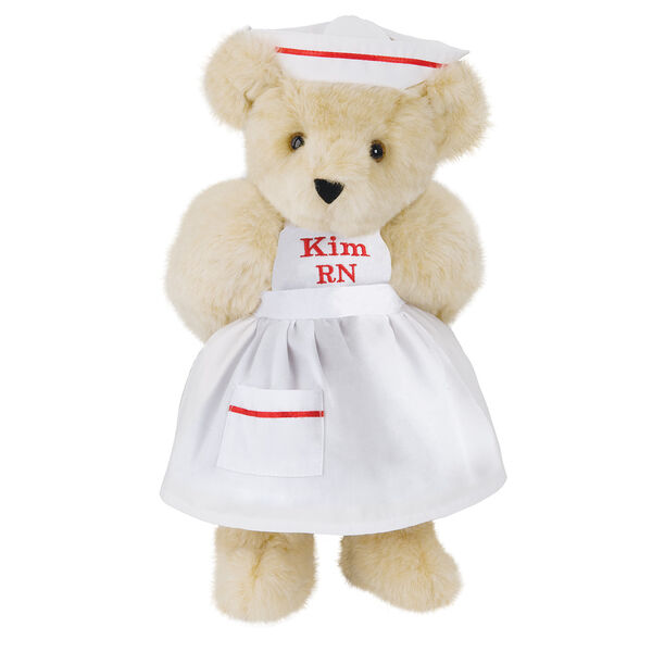 15" Nurse Bear - Front view of standing jointed bear dressed in white nurse's dress and hat with red trim perosnlized with "Kim RN" on bib of dress in red - Buttercream brown fur