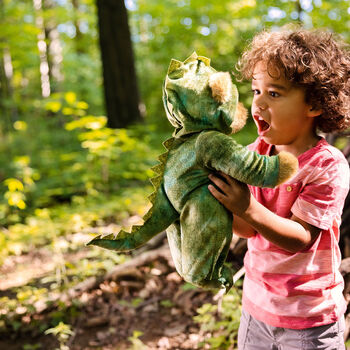 15" Dinosaur Bear - Side view of standing jointed bear with green textured hoodie footie in outdoor scene with model